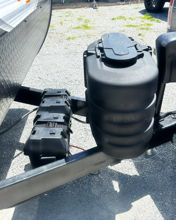 RV rental: Travel trailer's hitch area showing a black LP gas tank and three battery boxes.. Jayco Jay Flight 2023