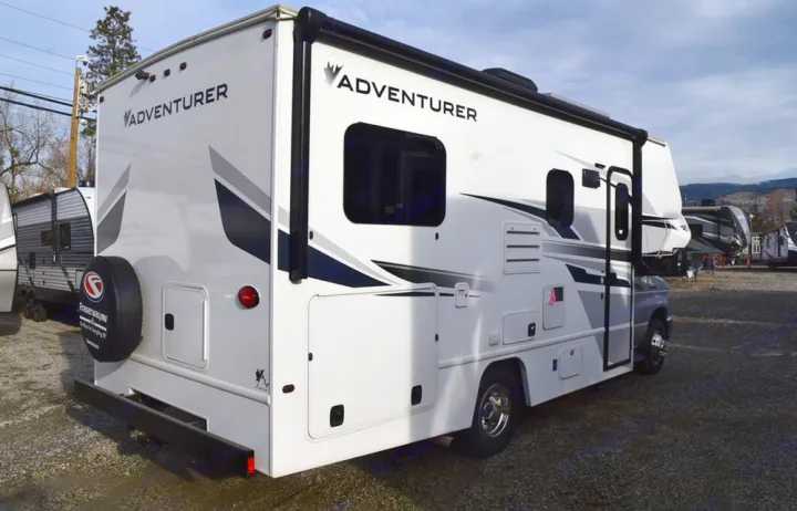 An Adventurer Class C motorhome, seen parked on a gravel lot, is ready for your next rv rental and outdoor adventure.. Adventurer Adventurer 2020