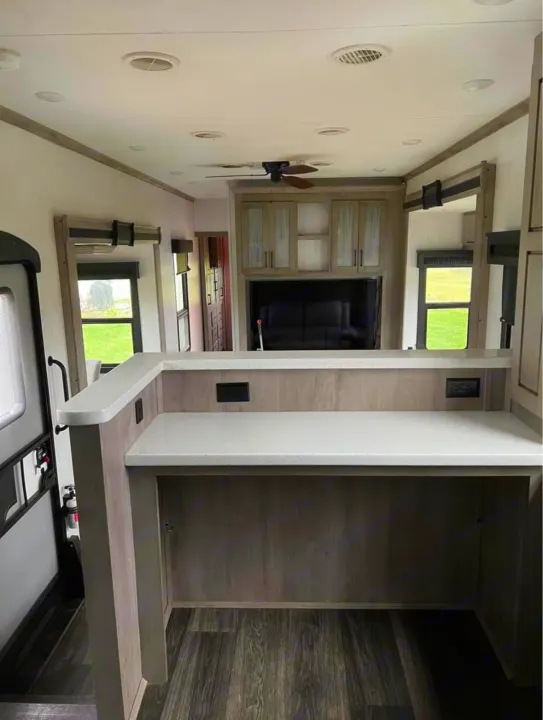Explore this modern RV rental interior featuring a spacious counter, entertainment area, and comfy seating.. Heartland RVs Big Country 2021