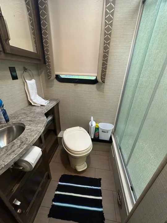 This RV rental bathroom features a compact toilet, sink, and shower stall. A convenient and clean space for your travels.. Jayco Greyhawk 2019