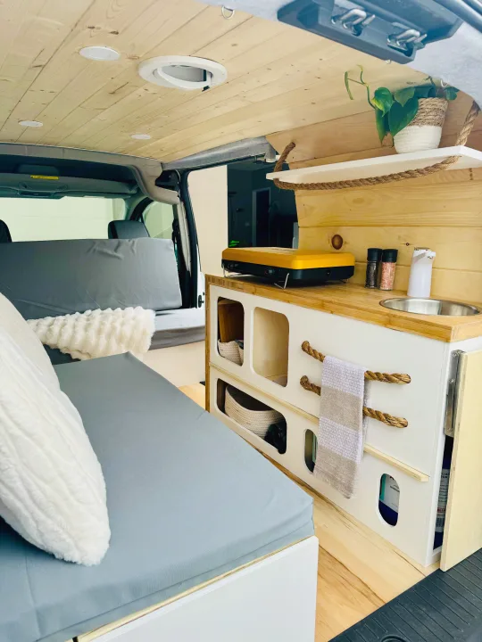 Kitchen includes a 2-burner propane campstove and running water!. Ford Transit 2015
