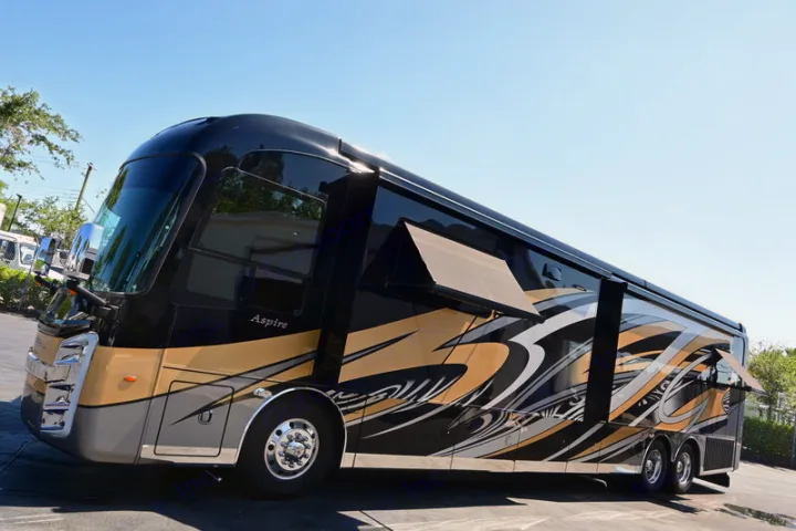 "Aspire" luxury RV available for rv rental: A striking black, gold, & silver motorhome with extended awnings.. Entegra Coach Aspire 2019