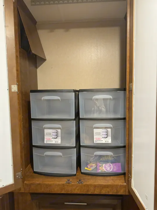 Optimized RV rental storage: Clear Sterilite drawers offer organized cabinet space, ideal for travel essentials.. Forest River FR3 2016