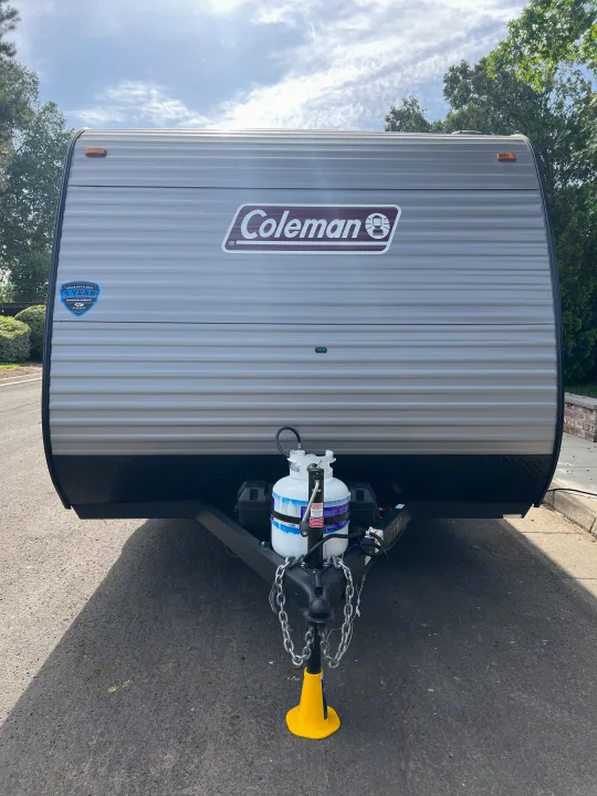 Front view of a gray Coleman travel trailer, with a propane tank and hitch. Perfect for an RV rental.. Coleman Lantern 17B 2024