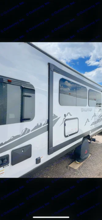 White Wolf Pup travel trailer RV with black windows and mountain graphics. Perfect for your next rv rental adventure!. Forest River Cherokee Wolf Pup Black Label 2022