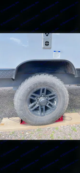 RV rental wheel secured on chocks & wood blocks. Essential for safe, level parking of your travel trailer.. Forest River Cherokee Wolf Pup Black Label 2022