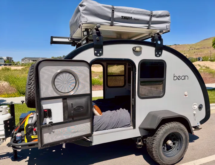 Sleek grey 'bean' teardrop camper with open door & Thule rooftop tent. Perfect RV rental for adventure.. Bean Trailer Bean Trailer Trailer 2019