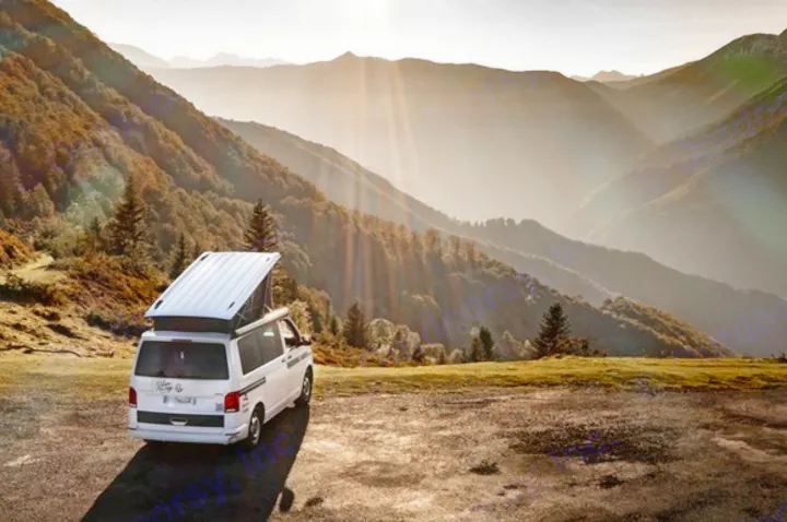 Experience freedom with an rv rental! White camper van parked on a mountain overlook, sunbeams illuminating scenic valleys.. Volkswagen California Coast T6.1 DSG7 2023
