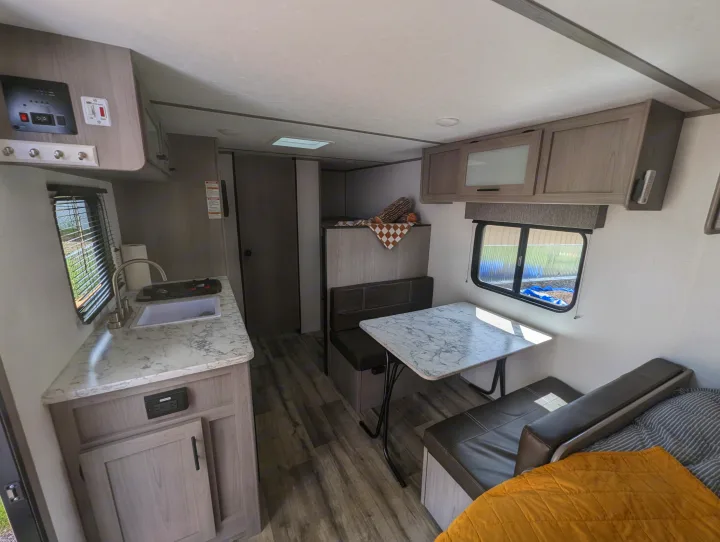 Spacious rv rental interior featuring a modern kitchen, comfortable dinette, and cozy sleeping area, perfect for travel.. Dutchmen Coleman Lantern 17B 2024