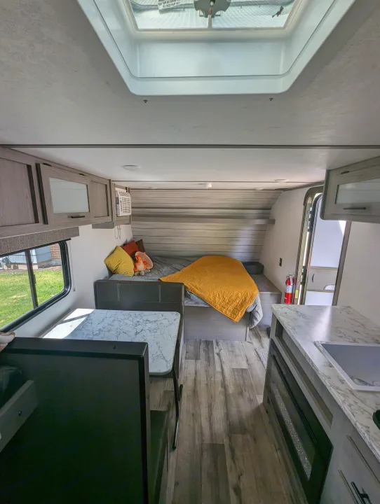 RV rental: Bright interior featuring a dinette, bedroom, kitchen, and skylight. Ready for adventure.. Dutchmen Coleman Lantern 17B 2024