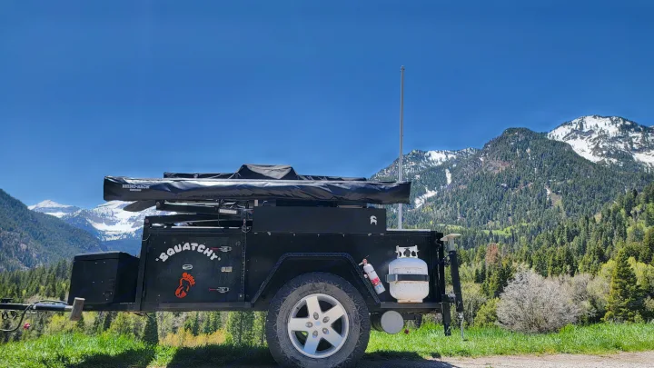 "Squatchy" black overland **rv rental** with awning & propane, ready for mountain camping adventure.. Insane Custom Trailers "Squatchy" 2022