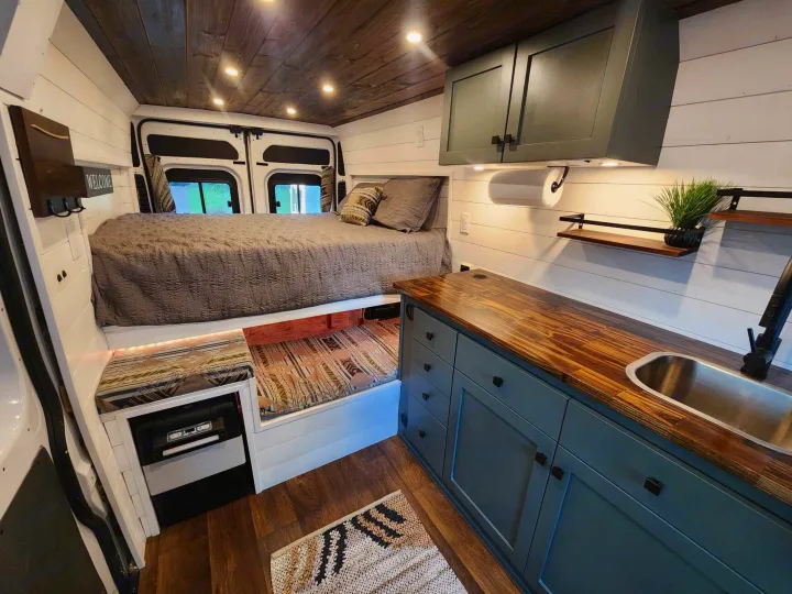 Step into this modern RV rental! Features a comfy bed, equipped kitchen, and clever storage in a custom van interior.. Dodge 1500 2014