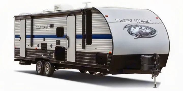Explore this Grey Wolf travel trailer, a spacious RV rental. Its exterior features a silver body, blue stripe, and wolf graphic.. Forest River Cherokee Grey Wolf Special Edition 2020