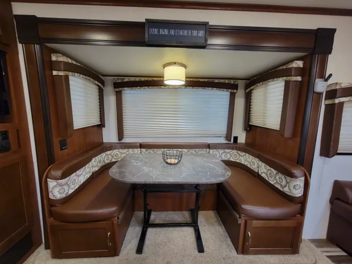 RV rental dinette: cozy U-shaped seating, marbled table, and ambient light. Your perfect spot to relax and explore!. jayco Jayflight 2017