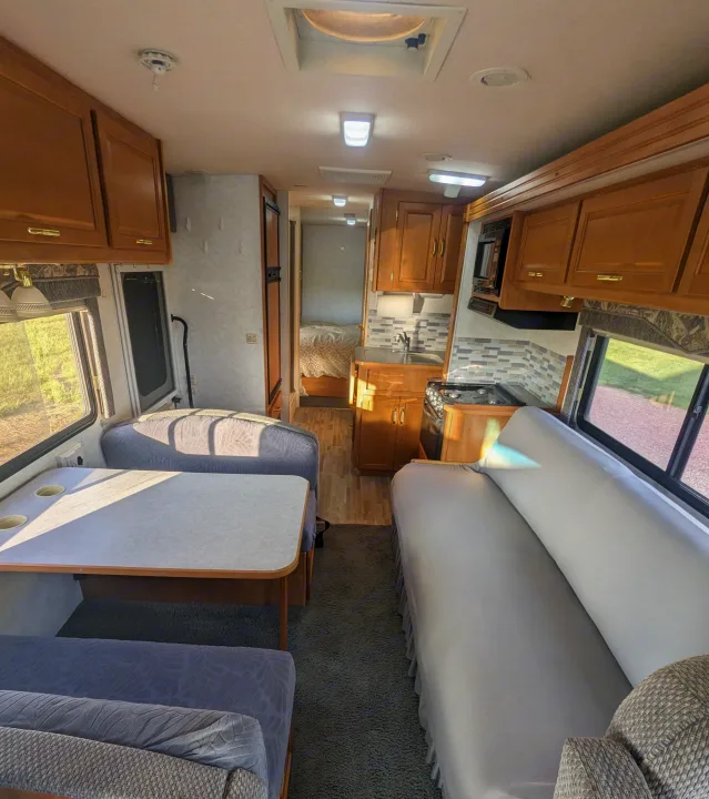Inside this RV rental, discover a well-equipped kitchen, dining area, comfy sofa, and a separate bedroom.. Itasca Sunova 2006