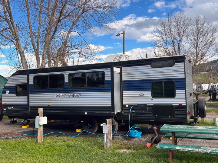 This Grey Wolf RV rental is fully set up at a scenic campsite, connected to utility hookups. Ready for adventure.. Forest River Cherokee Grey Wolf 2022