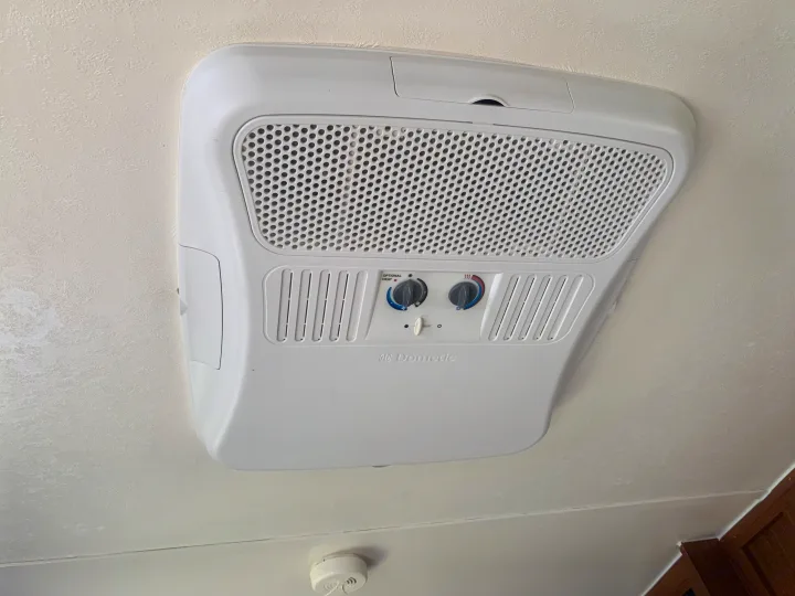 RV rental AC unit: Dometic ceiling air conditioner with heat controls, visible smoke detector.. Forest River Salem Cruise Lite 2015