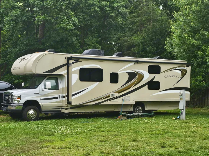 This Chateau RV rental is parked at a campsite, hooked up with water and power, ready for adventure.. Thor Chateau 2016