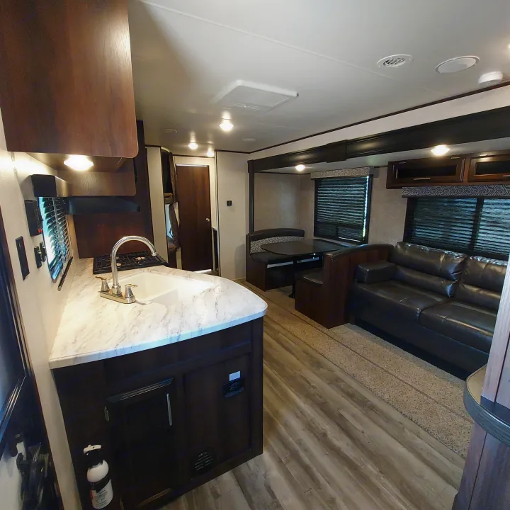 Spacious RV rental living area featuring kitchen, dinette, and sofa. Modern and well-equipped.. Jayco Jay Flight SLX8 2020