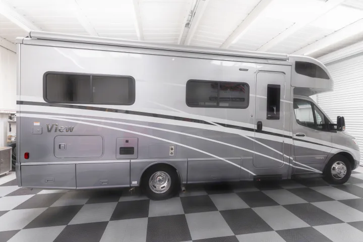 Silver Winnebago View Class C RV rental parked in a showroom, ready for adventure.. Winnebago View 2023