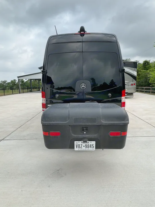 Luxury black Mercedes Sprinter camper van RV rental, equipped with a rear cargo box for extra storage.. Midwest Automotive Designs Super Sprinter 2019