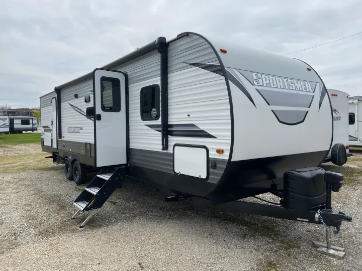 New grey/white Sportsmen travel trailer for RV rental. Steps down, ready for your next camping trip.. Sportsmen LE 2021