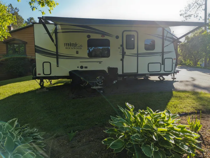 Mini Lite Rockwood RV rental, set up with awning extended for outdoor enjoyment on a sunny day.. Forest River Rockwood Mini Lite 2015