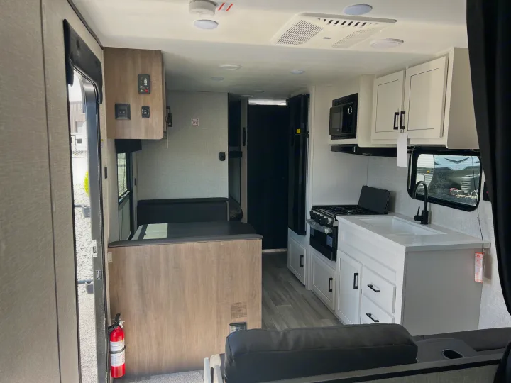 This RV rental offers a modern interior with a well-equipped kitchen, comfortable dinette, and living space.. Jayco Jay Flight SLX 2024