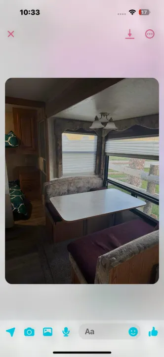 Inviting RV rental interior featuring a spacious dinette booth, table, and bright windows. Perfect for your next adventure!. Keystone RV Cougar 2006