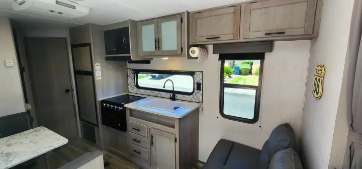 Step inside this RV rental! Features a compact kitchen with stove, sink, and microwave, a dinette, and a comfortable living space.. Dutchmen Coleman Lantern LT 2023