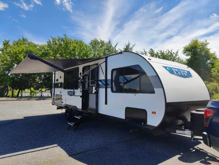 Spacious white RV rental with an extended awning, parked outdoors. Perfect for your next adventure!. Forest River Salem Cruise Lite 2024