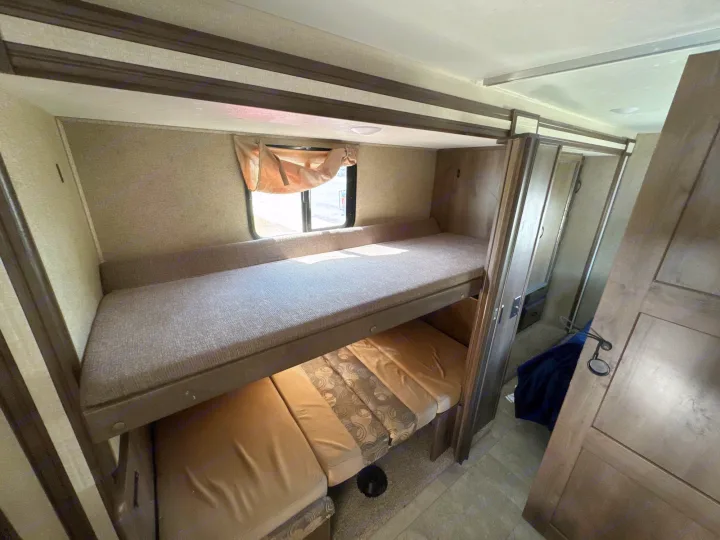 This RV rental bunkhouse features comfy bunk beds and a convertible lower seating area, perfect for family adventures.. Coachmen Freelancer 2019