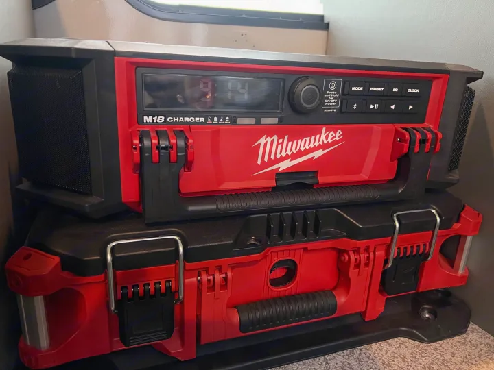 Milwaukee M18 radio charger on a PACKOUT box, ready for tunes and tool storage in an rv rental.. Chevrolet Express shuttle 2014