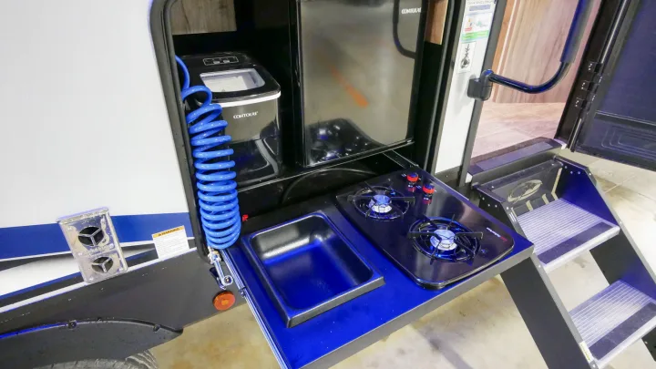 Explore your rv rental with this convenient outdoor kitchen, complete with a fridge, ice maker, sink, and two-burner stovetop.. Forest River Cherokee Alpha Wolf 2021