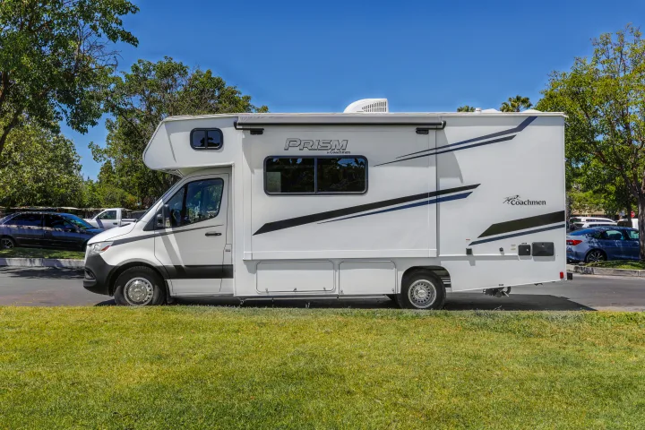 White Coachmen Prism RV rental parked on a sunny day, ready for your next adventure.. Coachmen Prism 2023