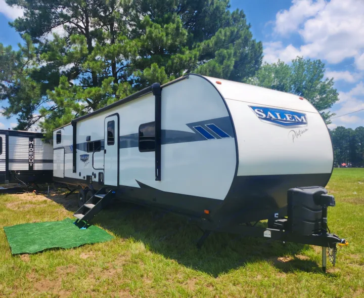 Spacious Salem Platinum travel trailer, white with black accents, ready for your next RV rental adventure.. Forest River Wildwood 2023
