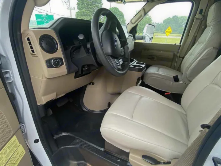 View of an RV rental's bright interior: front leather seats, dashboard, and steering wheel shown, ready for adventure.. Winnebago Spirit 22M ( R25085) 2025