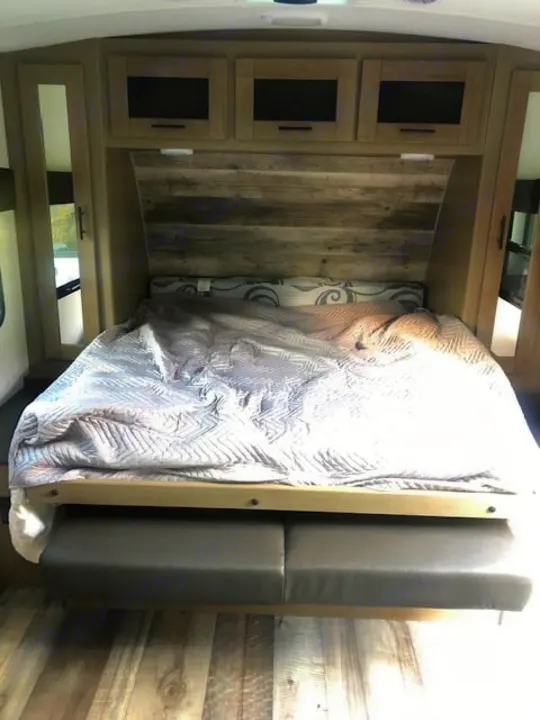 RV rental bedroom with a space-saving murphy bed over seating, ample overhead storage, and mirrored closets.. Heartland RVs Other 2022