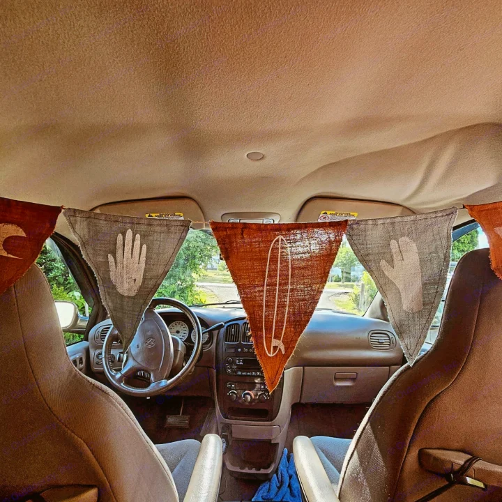 Inside an RV rental: Bohemian van interior with surfing & handprint bunting for a unique road trip.. Dodge Caravan 2003