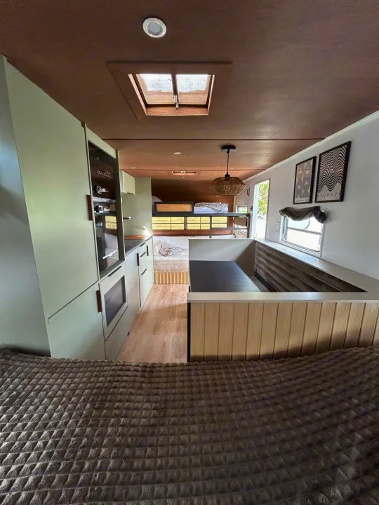 This modern rv rental interior features a functional kitchen, beds, skylight, and inviting living space.. Glendale Golden Falcon 1967