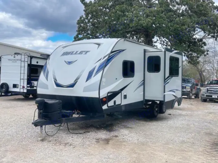 This sleek, white and gray Bullet travel trailer, perfect for an rv rental, awaits your next adventure on the road.. Keystone RV Bullet Ultra Lite 2018