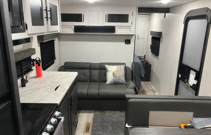 Discover this RV rental's modern interior: a compact kitchen, comfortable sofa, and inviting living area.. KZ Sportsmen 26BHSE 2022