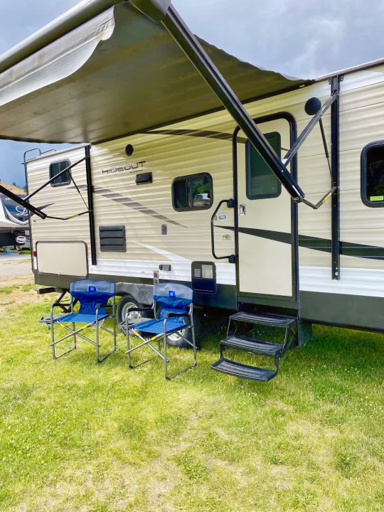 This travel trailer RV rental, with awning out & chairs, offers a great camping spot.. Keystone RV Hideout 2018
