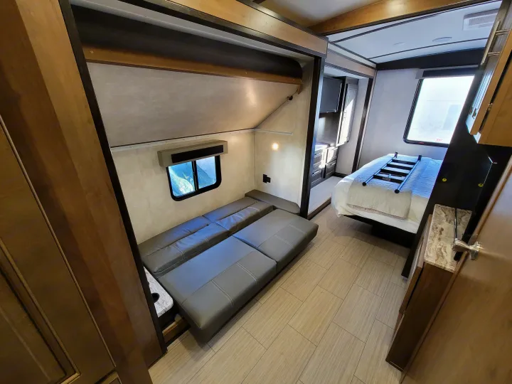 RV rental interior: bedroom with master bed and separate bunk area featuring a convertible sofa. Ready for your trip!. Forest River FR3 2020
