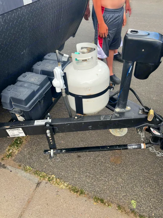 This rv rental features a front-mounted propane tank, dual batteries, and hitch hardware, crucial for road travel.. Coachmen Other 2021