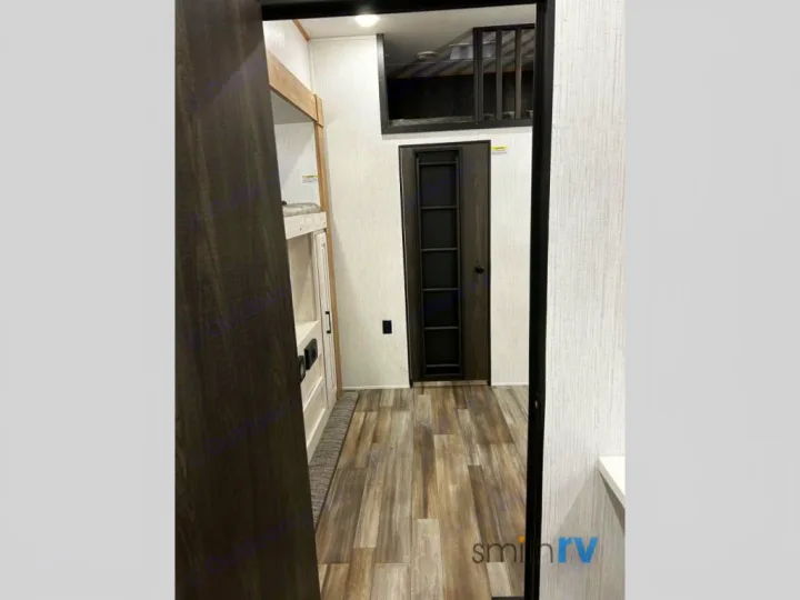 Explore this RV rental's inviting interior with bunk beds, a loft, and modern wood-look flooring. Ideal for comfortable travel.. Heartland Bighorn 2023