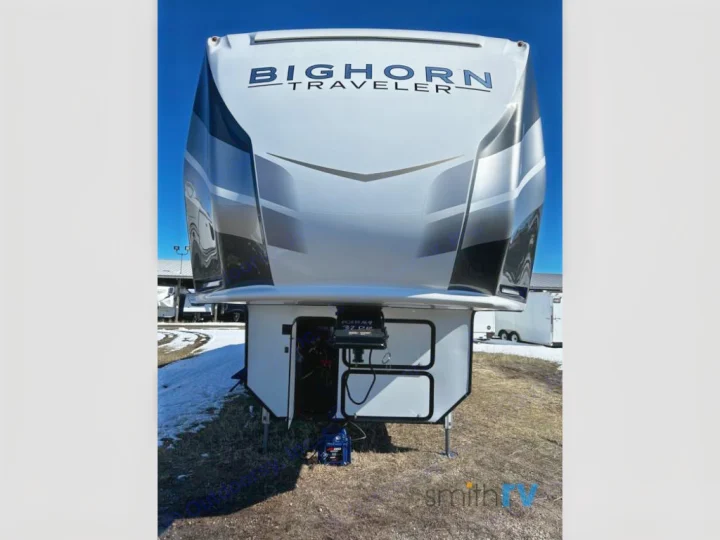 Front view of a white Bighorn Traveler fifth-wheel RV, perfect for an RV rental adventure or memorable camping trip.. Heartland Bighorn 2023