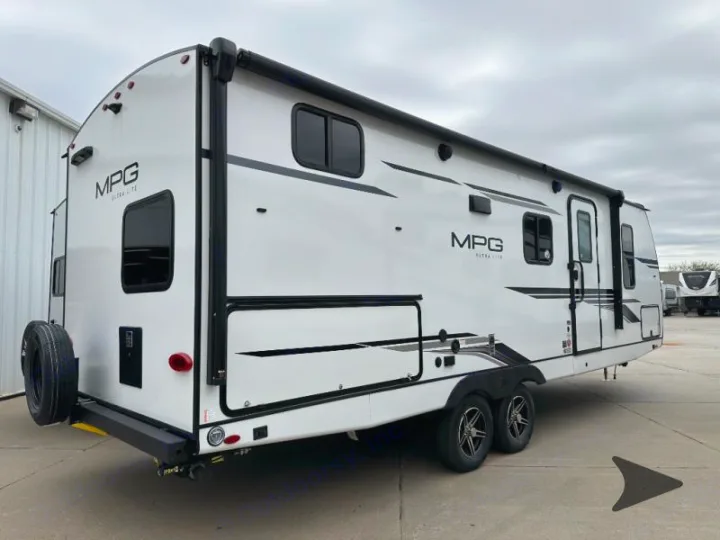 This white MPG Ultra Lite travel trailer, perfect for RV rental adventures, features a spare tire and multiple windows.. Cruiser RV MPG 2500bh 2024