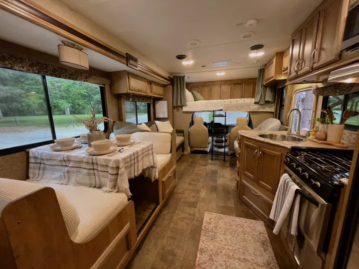 RV rental: Bright interior with dining area, full kitchen, and bunk bed over the cab.. Gulf Stream Conquest 2017