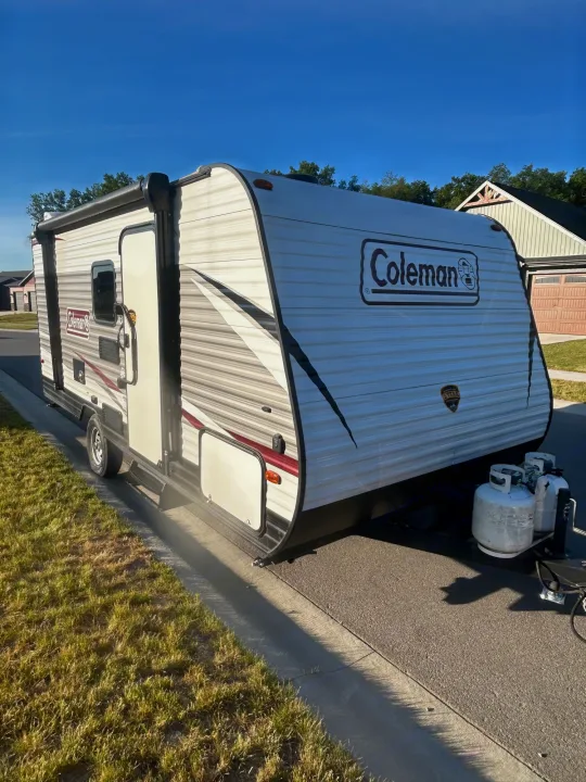 Sleek white Coleman RV rental parked on a sunny street, ready for your next travel adventure or camping trip.. Coleman Lantern 17FQ 2020